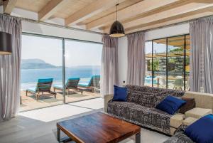 a living room with a couch and a view of the ocean at Ektoras in Plaka