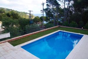 a large blue swimming pool in a yard at VISTA MAR - MEGIN in Tamariu