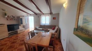 - un salon avec une table et un canapé dans l'établissement Apartmani Sirovica, à Čunski