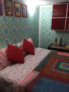 a bedroom with a bed with red pillows on it at Appartamento Rapisardi Centro in Catania