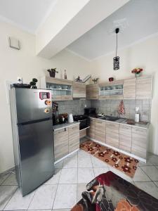 a kitchen with a stainless steel refrigerator at See and City Apartment in Aigio