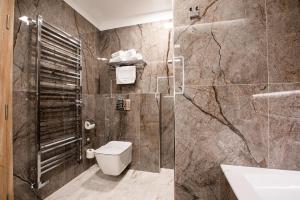 a bathroom with a toilet and a sink at Hotel Pod Zamkem in Velké Meziříčí