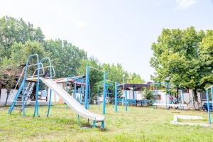 a playground with a slide in a park at Bungalow Silitur in Ahtopol