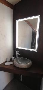 a bathroom with a sink and a mirror at Casita colgada "Can Lia" in La Guancha