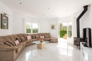 a living room with a couch and a coffee table at Villa Moll Moll in Cala Blanca