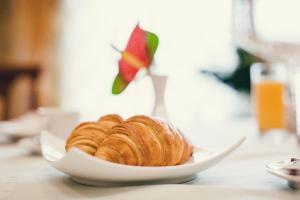 a plate of croissants on a table at Denisa Boutique in Poiana Brasov