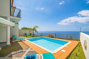a swimming pool with a view of the ocean at Boavista in Calheta