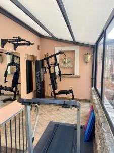a gym with treadmills and a treadmill at Relais 147 - Luxury b&b in Taormina