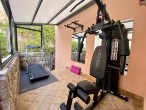 a fitness room with a gym with a treadmill at Relais 147 - Luxury b&b in Taormina