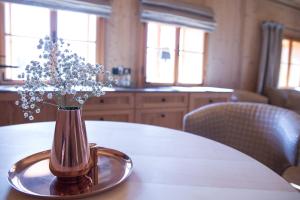 a vase with flowers in it sitting on a table at Hotel Winterbauer in Flachau