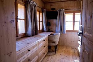 a room with a bench in a cabin with windows at Hotel Winterbauer in Flachau
