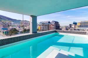 a swimming pool with a view of a city at Backup-Powered Trendy City Balcony Apartment in Cape Town