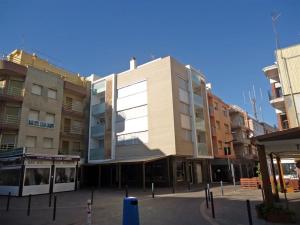 a large building in front of some buildings at Ermitana 6 in Peñíscola
