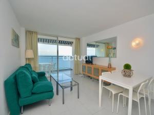 a living room with a green couch and a table at Elypalace 16 -2 in Platja  d'Aro