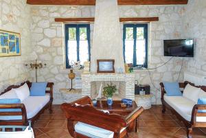 a living room with couches and a fireplace at Niovi in Agios Leon