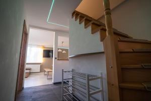 a staircase in a room with a stair case at Ferienhaus Thüringer Wald - Garten & Terrasse in Bischofrod