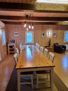a dining room with a large wooden table and chairs at Anhults Garden in Orkelljunga