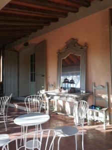 a room with chairs and a table and a mirror at La Torretta in Lari