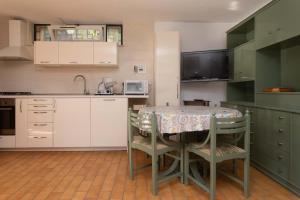 a kitchen with a table with chairs and a sink at N91 - Numana, nuova taverna bilocale in Numana