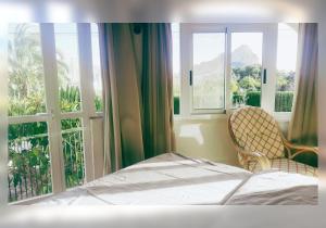 a bed and a chair in a room with a window at Casa Kollies in Calpe +59 photos