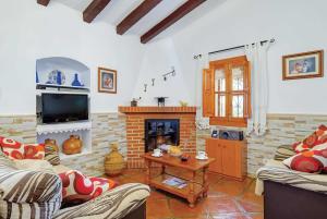 a living room with two couches and a fireplace at Urdiales in Frigiliana