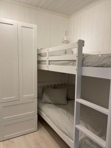 a room with two bunk beds and a cabinet at Brissundsbyn in Visby