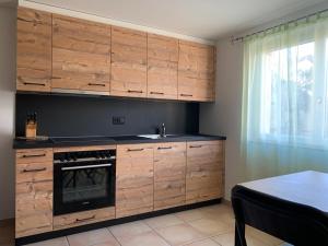 a kitchen with wooden cabinets and a sink at Haut de Cry in Conthey