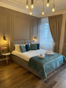 a bedroom with a large bed with two towels on it at Von Cruss apartments in Lviv in Lviv