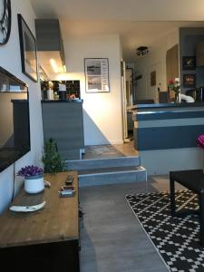 ein Wohnzimmer mit einer Treppe, die zu einer Küche führt in der Unterkunft Les marinas vue Mer in Deauville