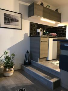 a kitchen with stairs leading up to a counter at Les marinas vue Mer in Deauville