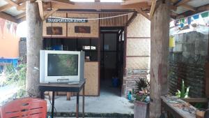 a television sitting on a table in front of a building at Toraja ManuBackPacker in Rantepao