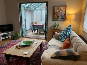 a living room with a couch and a table at Pretty Cottage in Central Lewes in Lewes