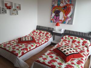 two beds sitting next to each other in a room at Les sables d’or in Saint-Jean-de-Monts