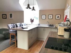 a kitchen with a island in the middle of a room at The Courtyard Apartment at Cefn Tilla Court, Usk in Usk