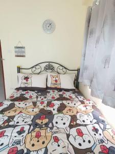 a bedroom with a bed with cartoon animals on it at C&TApartment in Ban Thai Don (1)