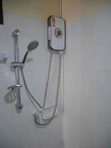 a shower in a white bathroom with a shower at C&TApartment in Ban Thai Don (1)