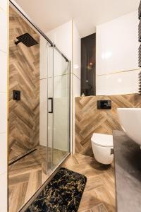 a bathroom with a shower and a toilet and a sink at Flatbook - City Center Apartments Waterlane Vintage with Gym in Gdańsk