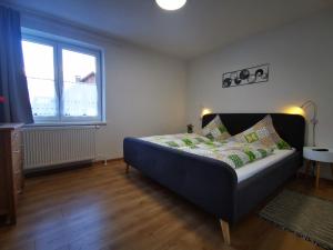 a bedroom with a bed in a room with a window at Pension Bergfried in Hallstatt