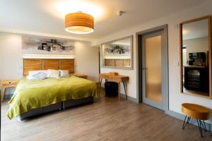 a bedroom with a bed and a table and a desk at Magnolia House, Rye in Rye