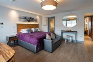 a bedroom with a bed and a table and a mirror at Magnolia House, Rye in Rye