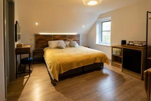 a bedroom with a large bed and a desk at Magnolia House, Rye in Rye