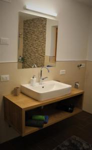 a bathroom with a white sink and a mirror at Lü de Terza in San Vigilio Di Marebbe