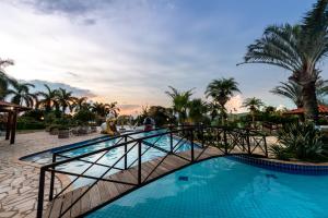 a bridge over a pool at a resort at Obbá Coema Village Hotel in Capitólio