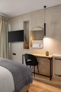 a bedroom with a desk and a bed and a mirror at Hypnos Cozy Living in Ioannina
