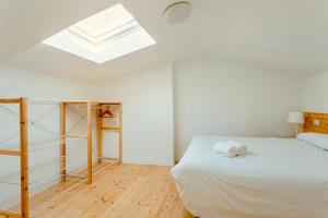 a bedroom with a bed and a skylight at Downtown La Torre in A Coruña