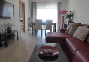 Una sala de estar con un sofá rojo y una mesa. en Casa Marques, en Lagos