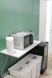a microwave sitting on a shelf next to a wall at Last Minute Ferrara in Ferrara +36 photos