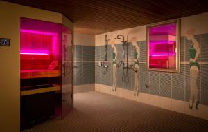 a bathroom with a shower and pink lights in it at Hotel Am Kurpark Späth in Bad Windsheim +51 photos