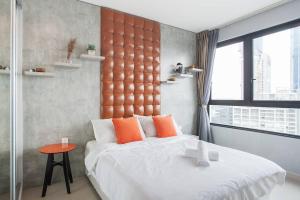 a bedroom with a large bed with an orange headboard at iCity 1Bedroom Apt Near Mall & ThemePark RM59 in Shah Alam +13 photos