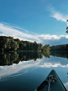 a kayak on a lake with trees in the background at Vintage tent at the Lovsin Estate in Metlika